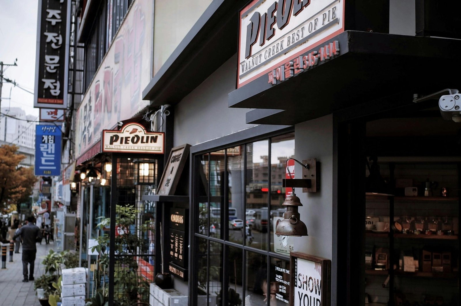 Explore the lively streets of Gamjeon-dong, Busan featuring shops and cafes.